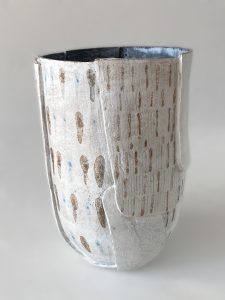 White slab-built stoneware vessel with drop and line motifs, three quarter view,  by Alexandra Ridel