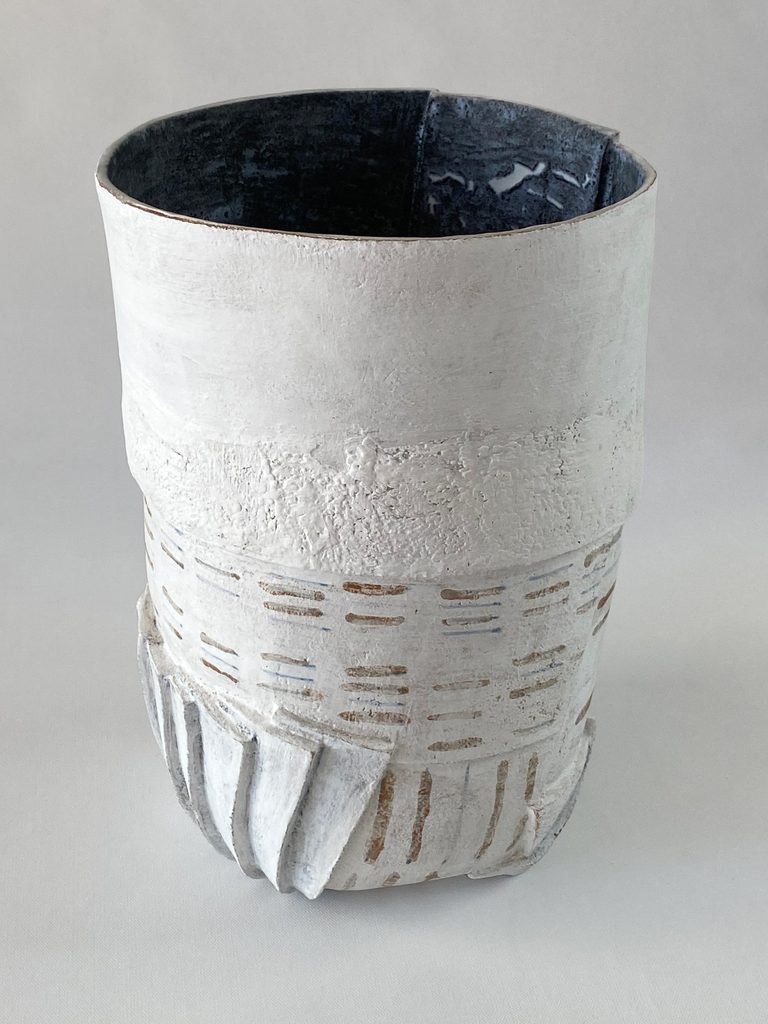 Slab-built stoneware volume with large  white slab and ase formed by multiple clay folds , by Alexandra Ridel