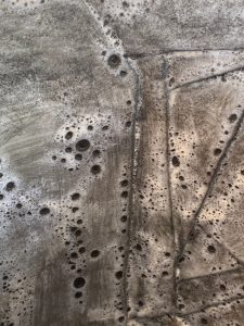 Detail of the interior of a vessel with a dark foamy glaze, by Alexandra Ridel