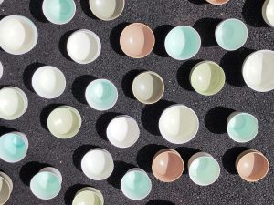 Collection on coloured porcelain cups on dark background by Alexandra Ridel