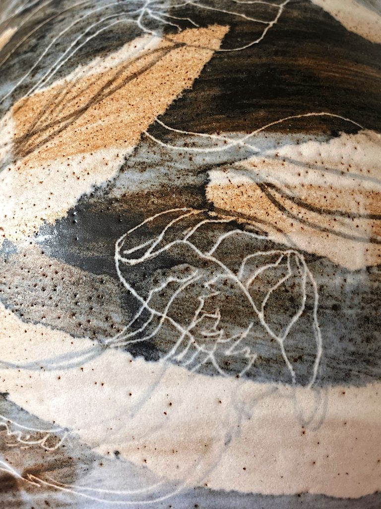 Detail of a jellyfish floating motif on a stoneware vessel, by Alexandra Ridel