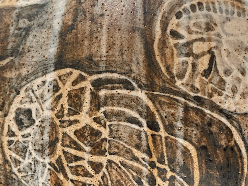 Motif of a jellyfish on a stoneware vessel, by Alexandra Ridel