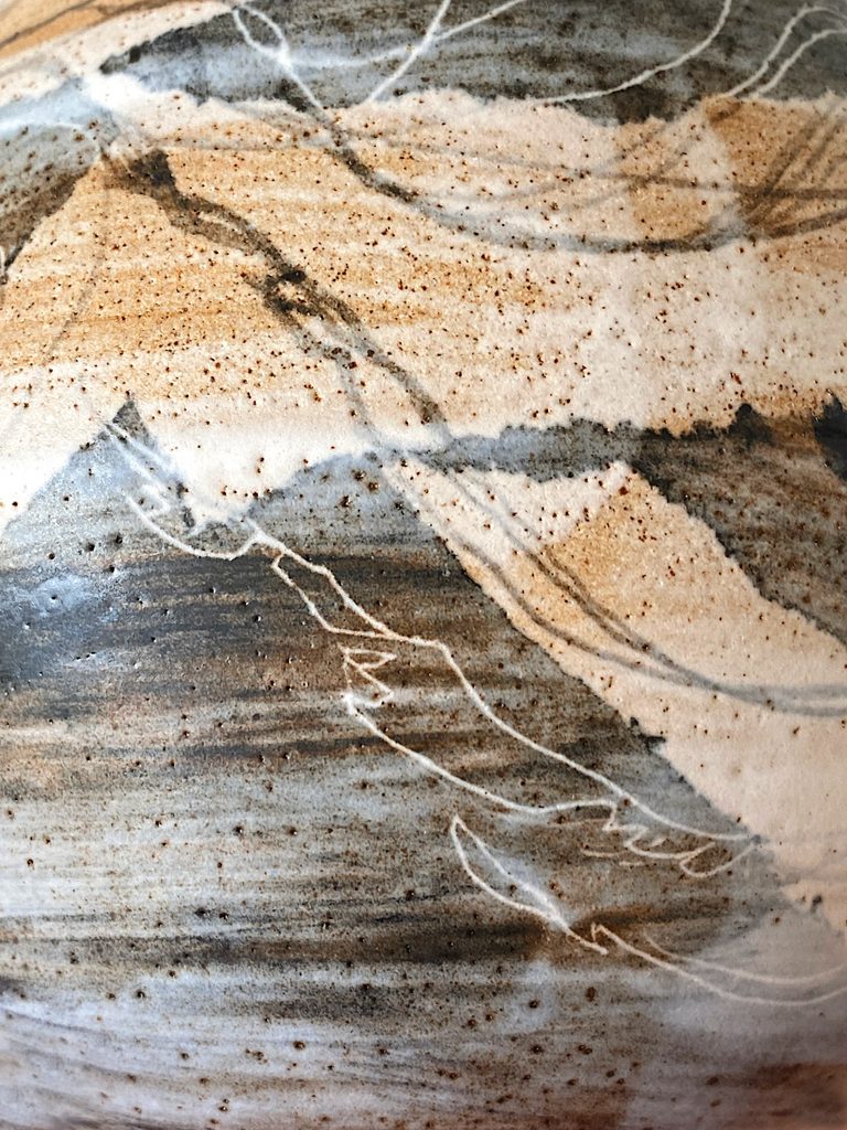 Detail of a jellyfish motif and brushstrokes on a stoneware vessel, by Alexandra Ridel