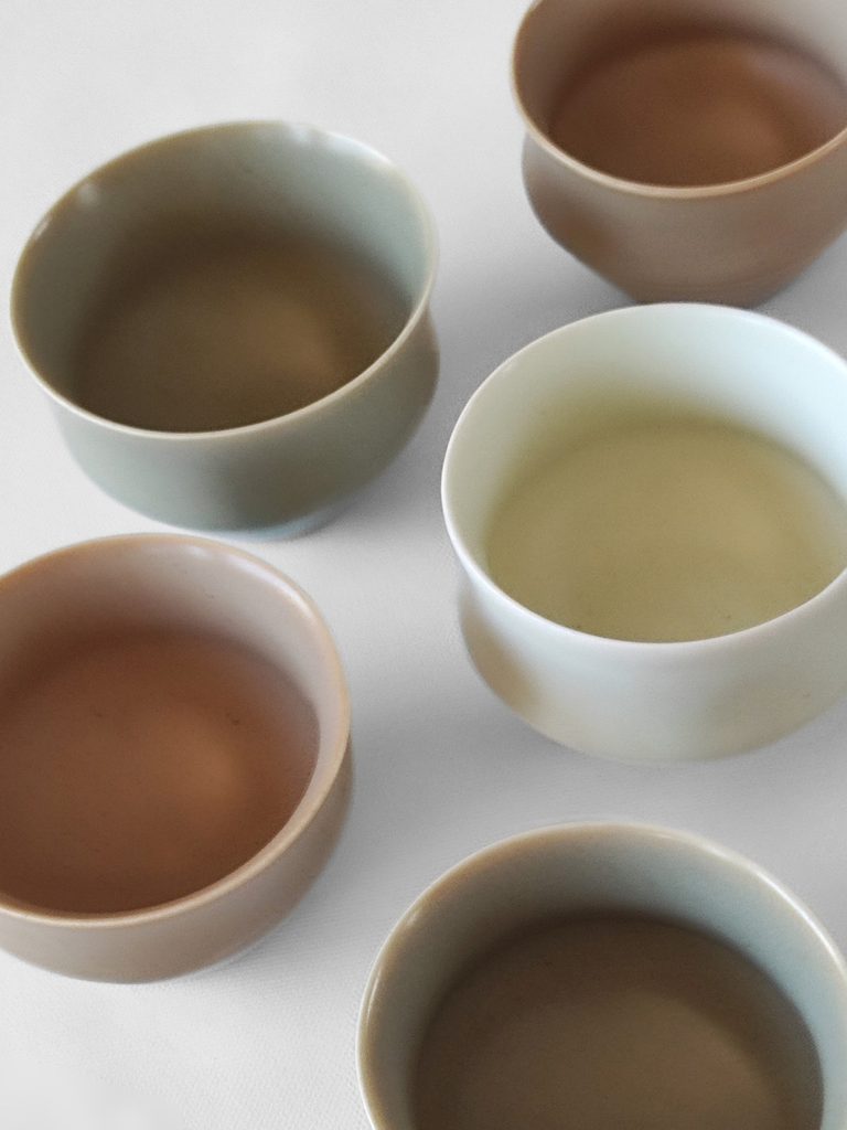 Collection of porcelain cups with satin colored glaze by Alexandra Ridel