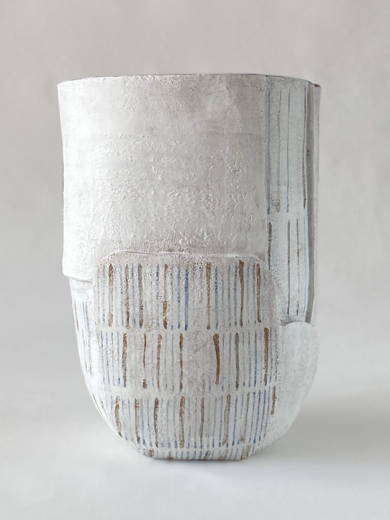Slab-built stoneware volume with thin brown and blue lines motifs on a white background by Alexandra Ridel